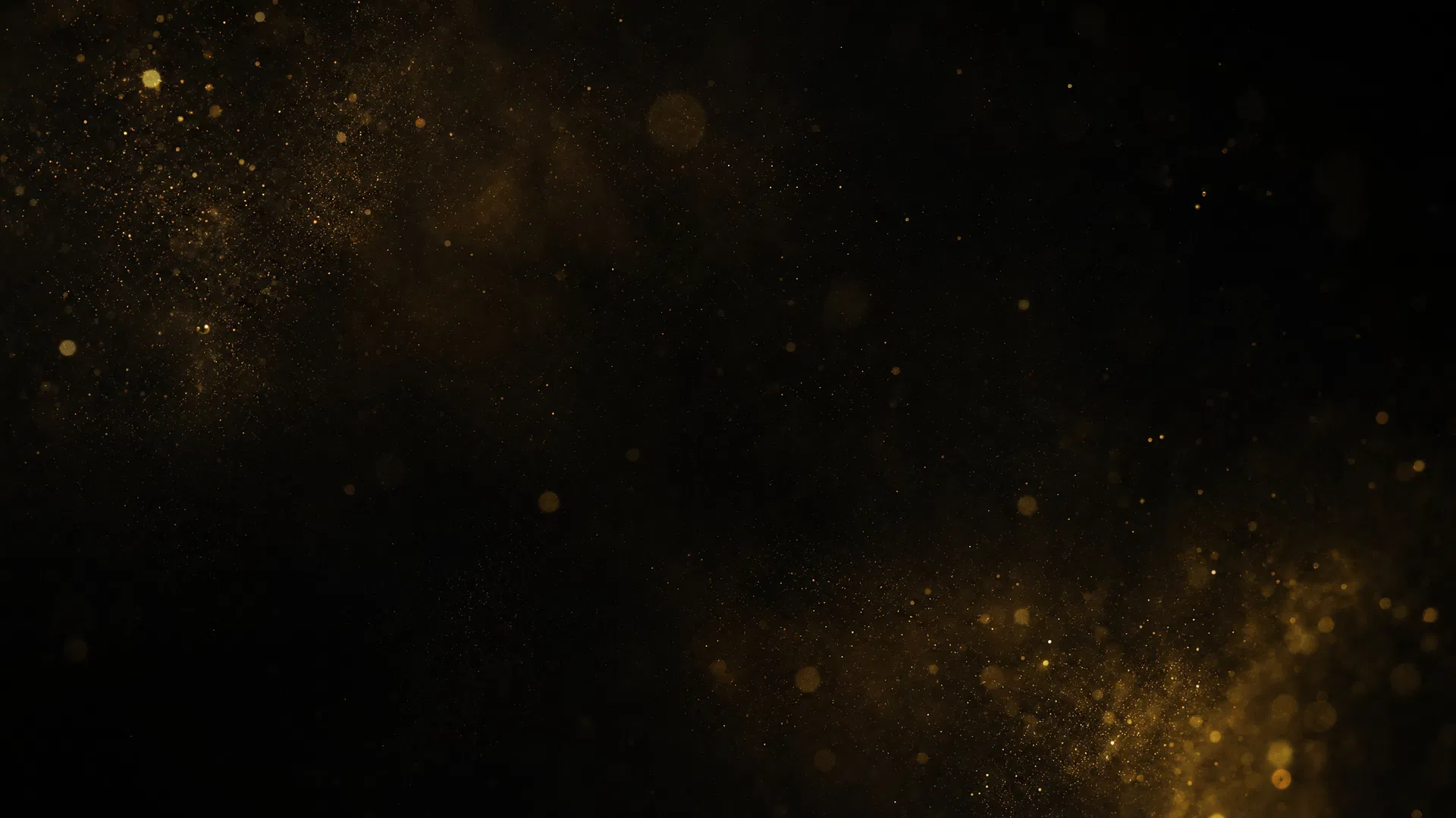 Abstract golden dust particles on dark background