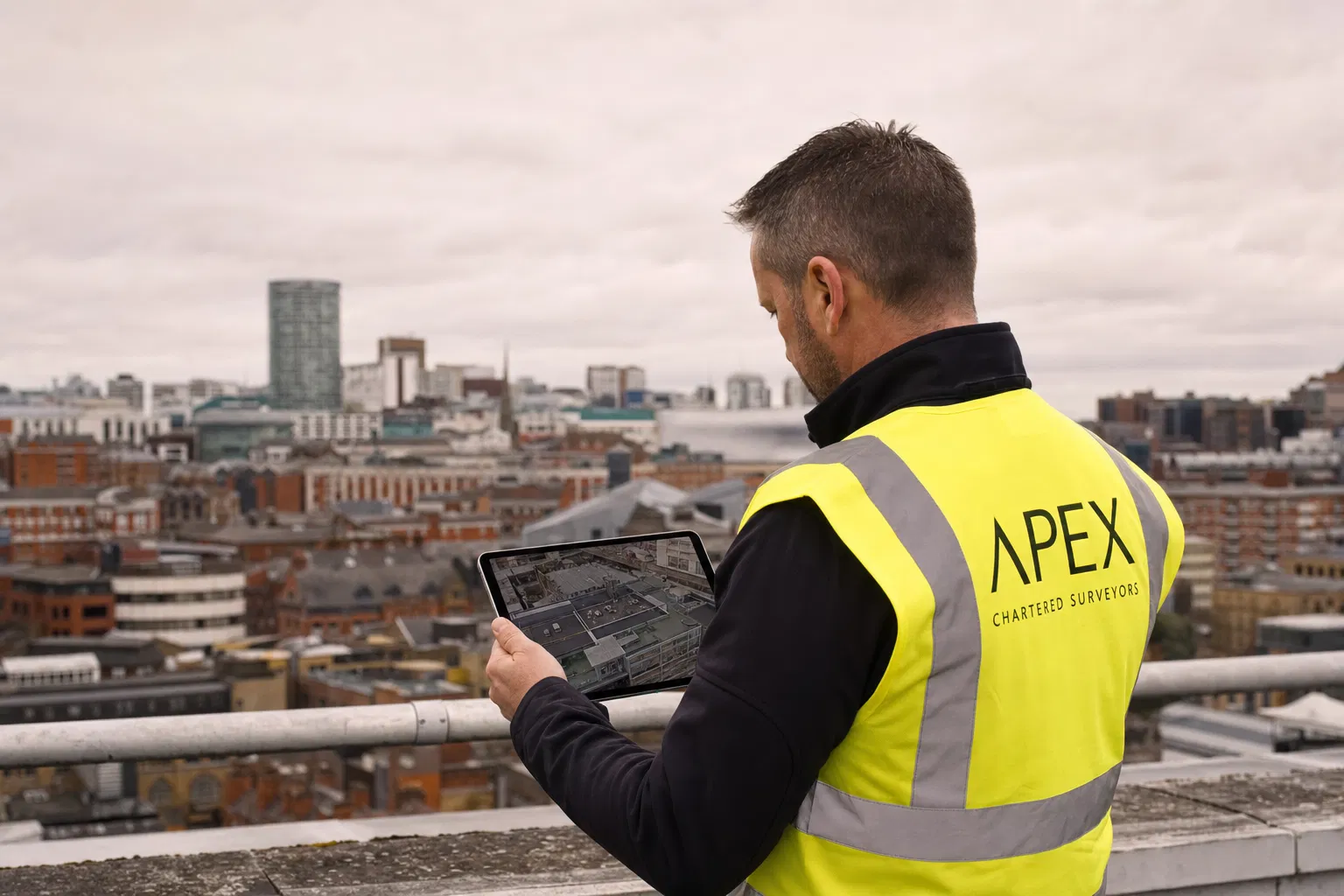 Building surveyor reviewing drone data on tablet