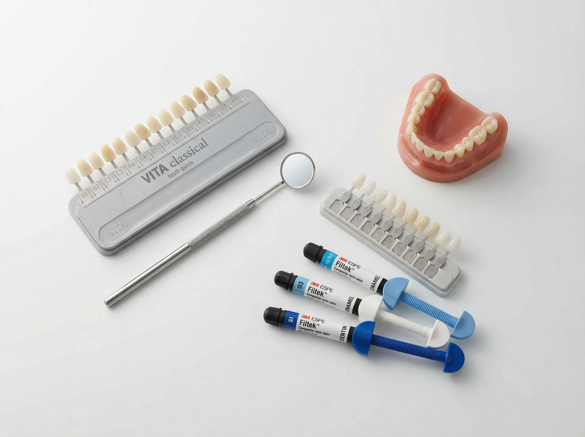 Cosmetic dental tools and materials including shade guide, composite syringes, and veneer samples at Oakridge Park Dental Vancouver BC
