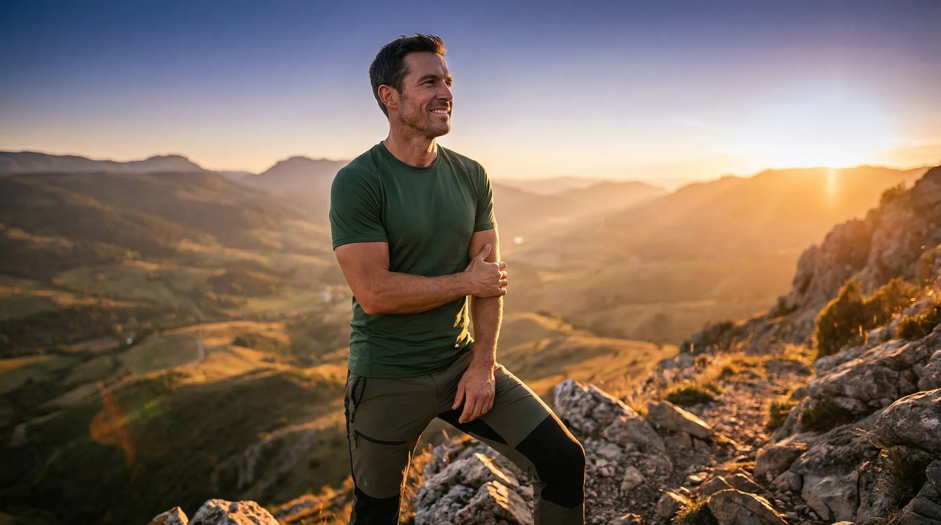 Athletic man on mountain at golden hour