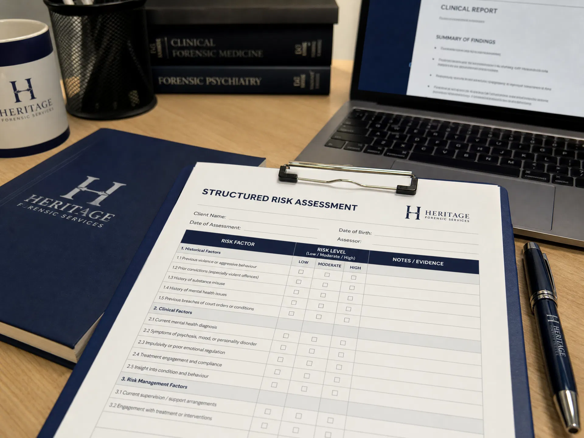 Structured risk assessment form on a desk with clinical report open on laptop