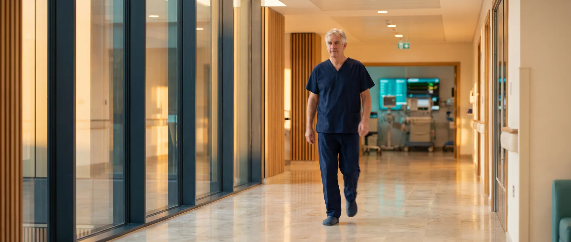 Modern UK hospital corridor with specialist surgeon