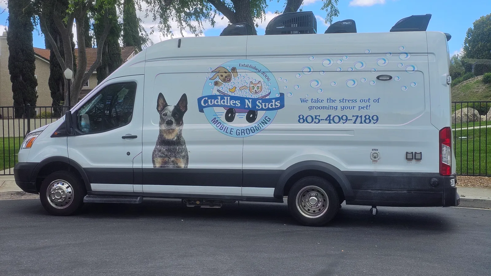 Cuddles N Suds mobile pet grooming van with Blue Heeler dog graphic in Thousand Oaks.