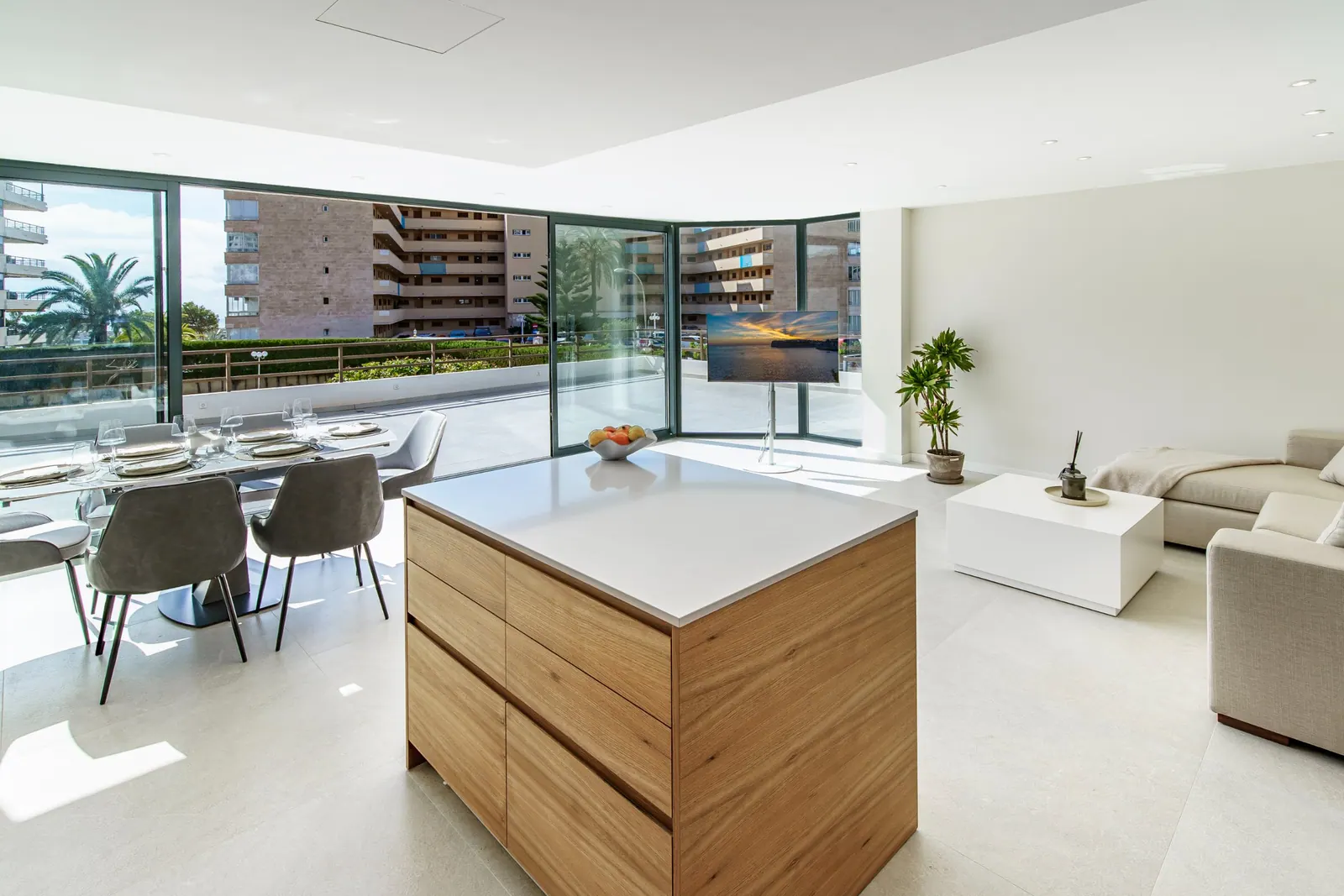 Open-plan kitchen, dining and living area opening to a terrace in Portals Nous