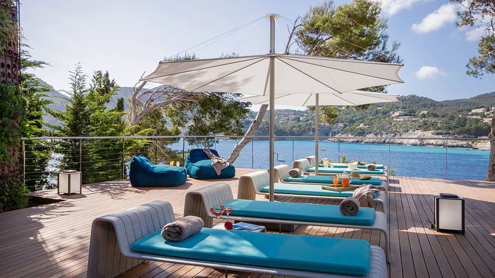 Sea-view terrace with sun loungers above the bay at a clifftop estate in Camp de Mar, Mallorca