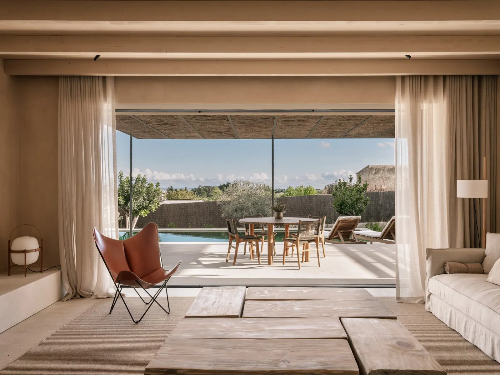 Living room opening onto a pool terrace in a new villa in Establiments, Palma