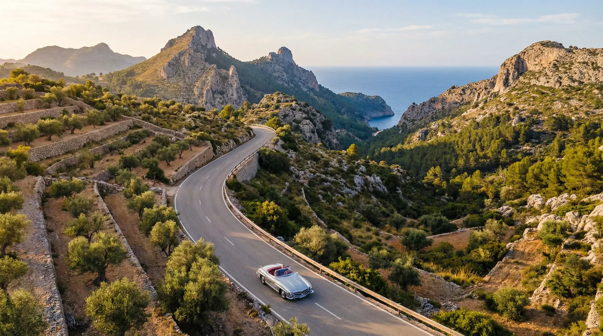 A white Porsche 911 on a winding mountain road in Mallorca