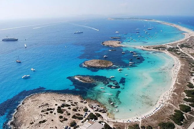 Aerial view of luxury yachts anchored in turquoise water off Ses Illetes, Formentera.
