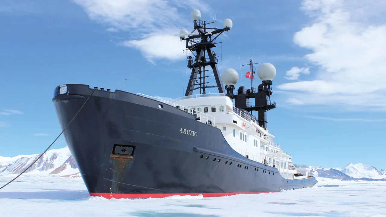 Explorer yacht navigating through Arctic ice near Svalbard