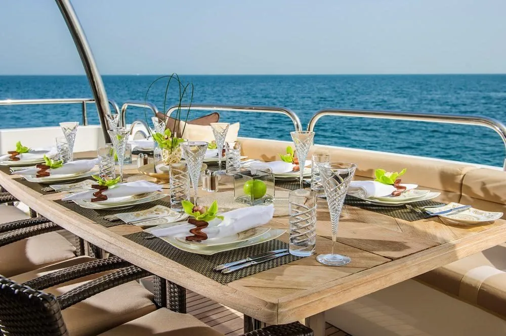 Elegant fine dining table setting on a superyacht deck