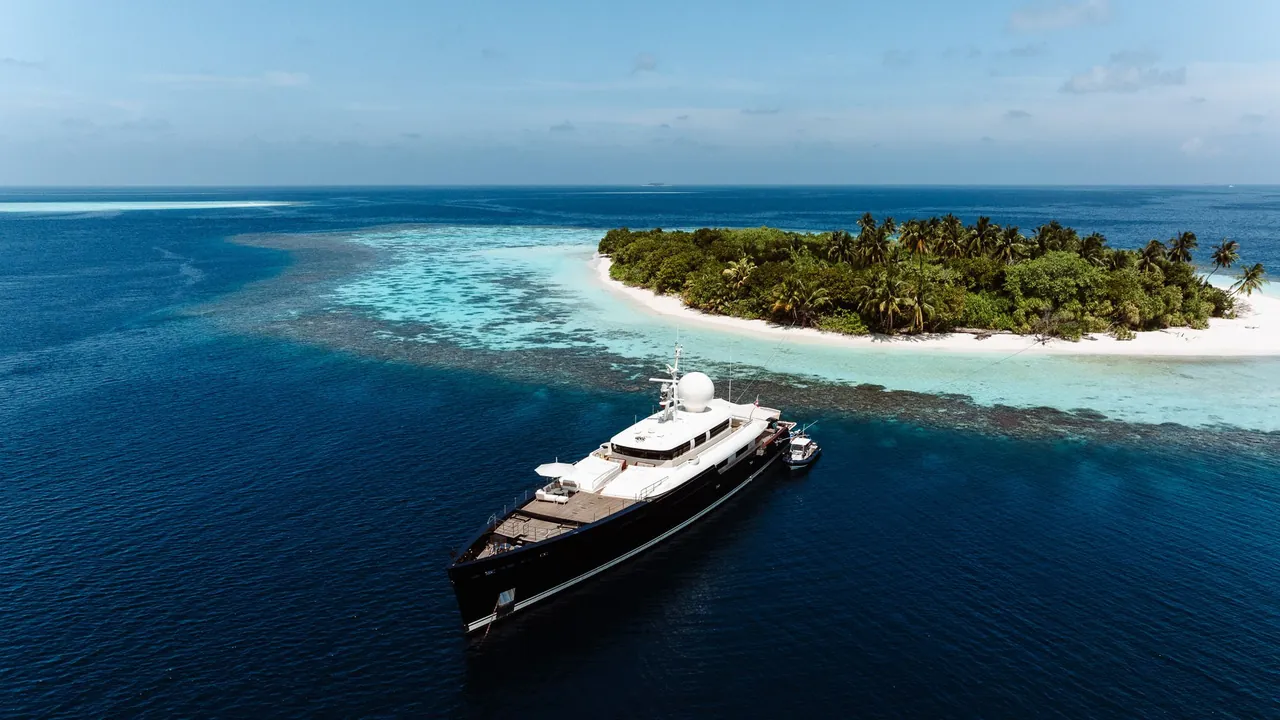 Superyacht approaching a private island in the Maldives