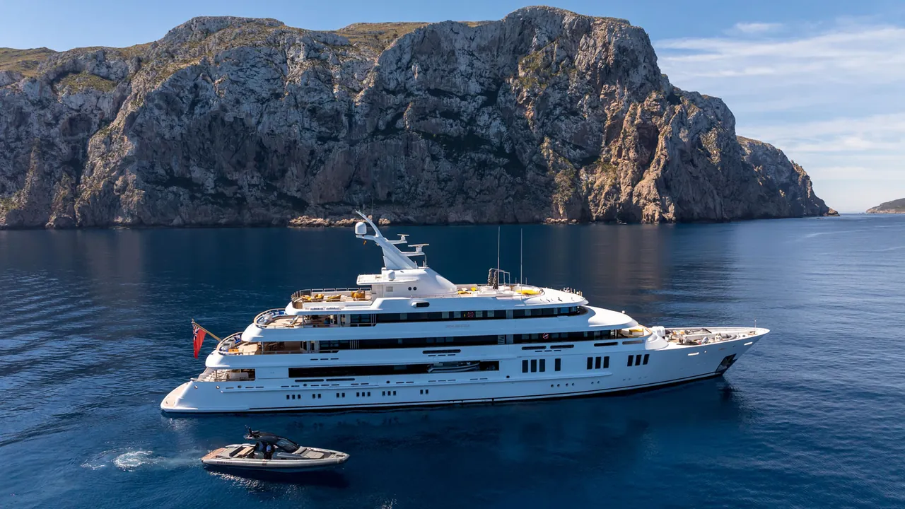 Aerial view of a luxury motor yacht and chase boat off Cap de Formentor, Mallorca.