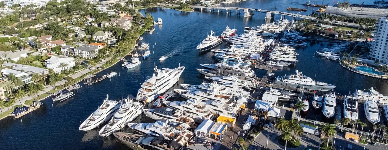 Aerial view of luxury yachts moored at a Fort Lauderdale marina during a boat show.