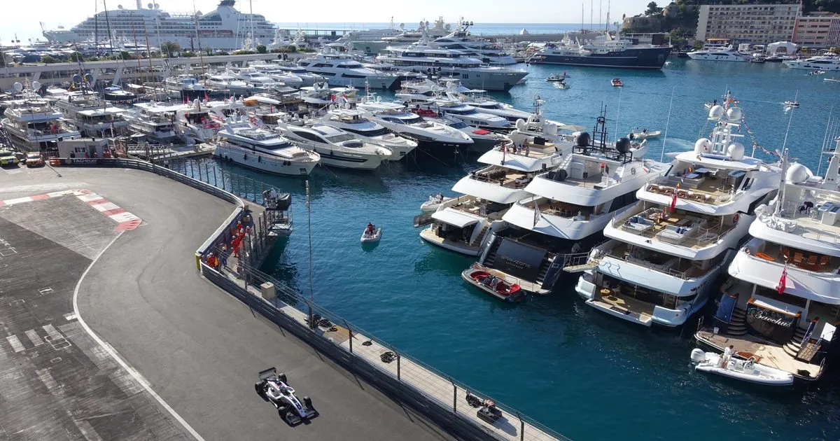 Aerial view of luxury yachts docked in Monaco’s Port Hercule beside the Formula 1 track