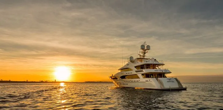 Aerial view of luxury motor yacht Aurora cruising at sunset in an unidentified location.