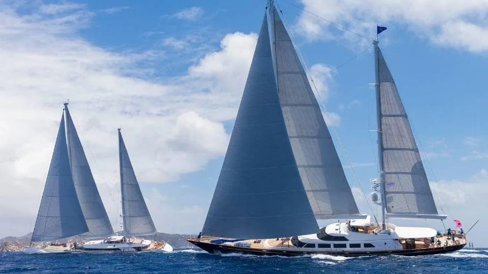 Aerial view of schooners Athos and Meteor racing at the St Barths Bucket, with crew visible on deck.