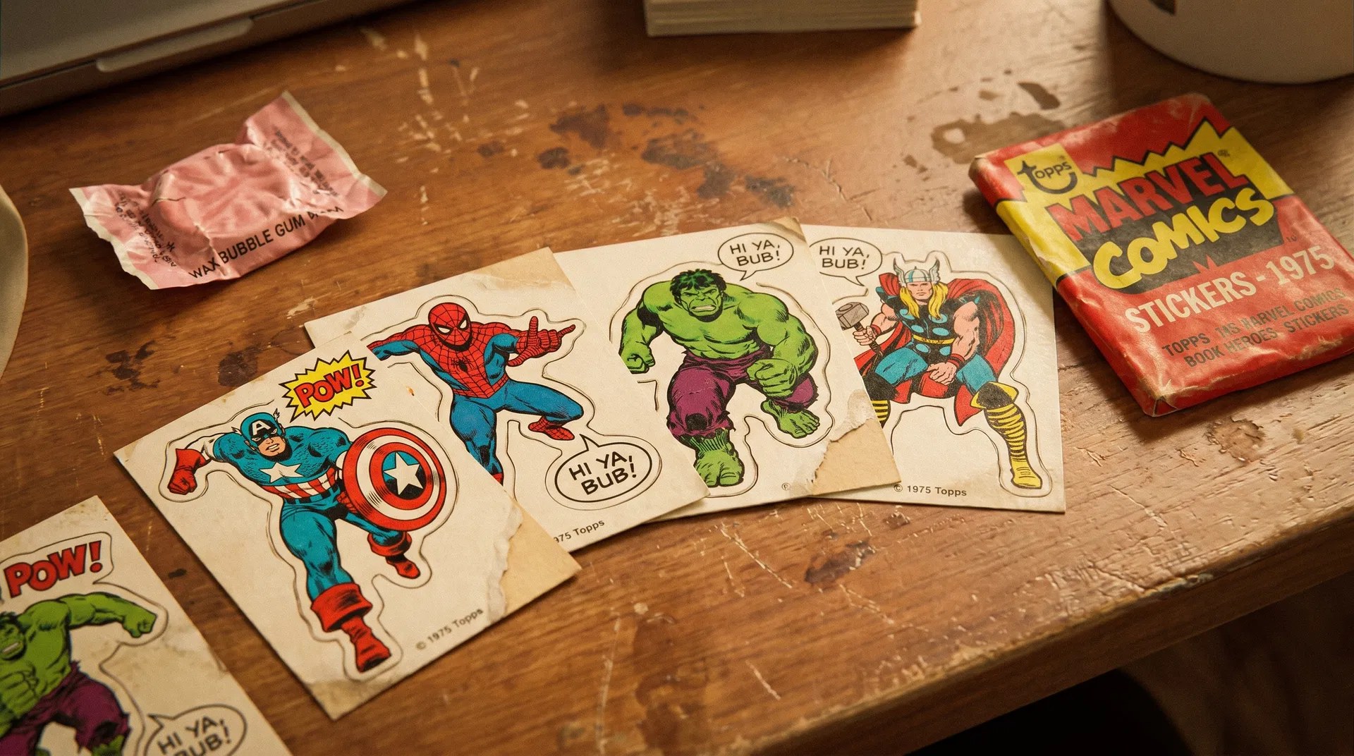 Vintage 1975 Topps Marvel Comic Book Heroes sticker cards on a wooden desk