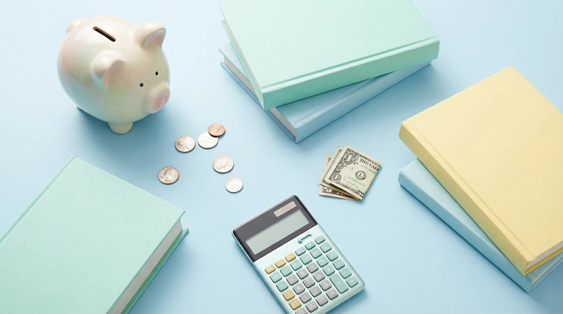 College student financial planning with textbooks, calculator and piggy bank