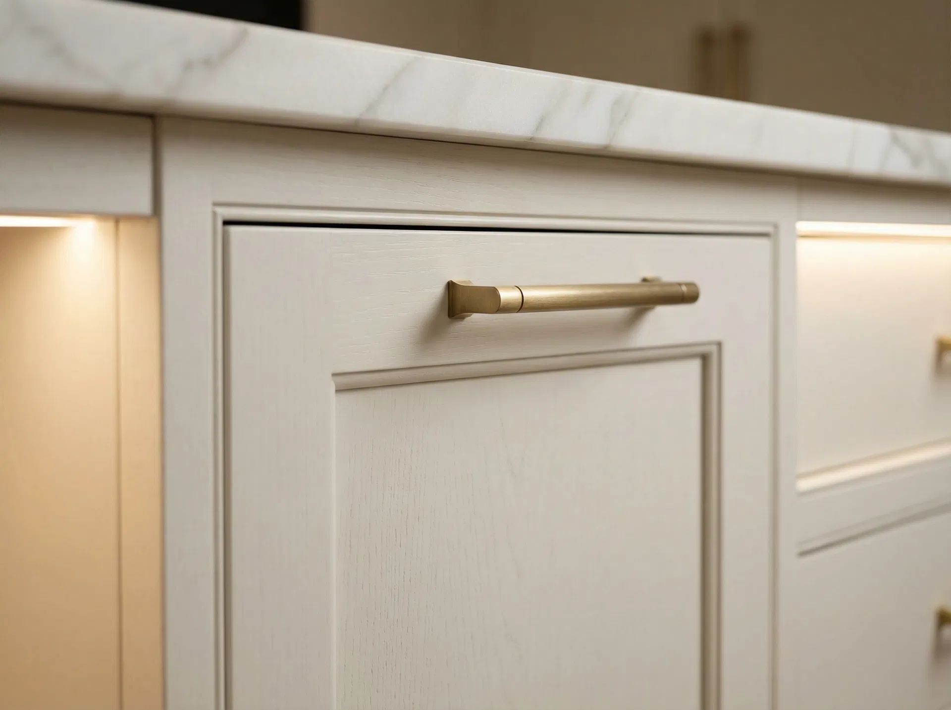 Magnolia cabinetry detail — brass hardware on white inset panel