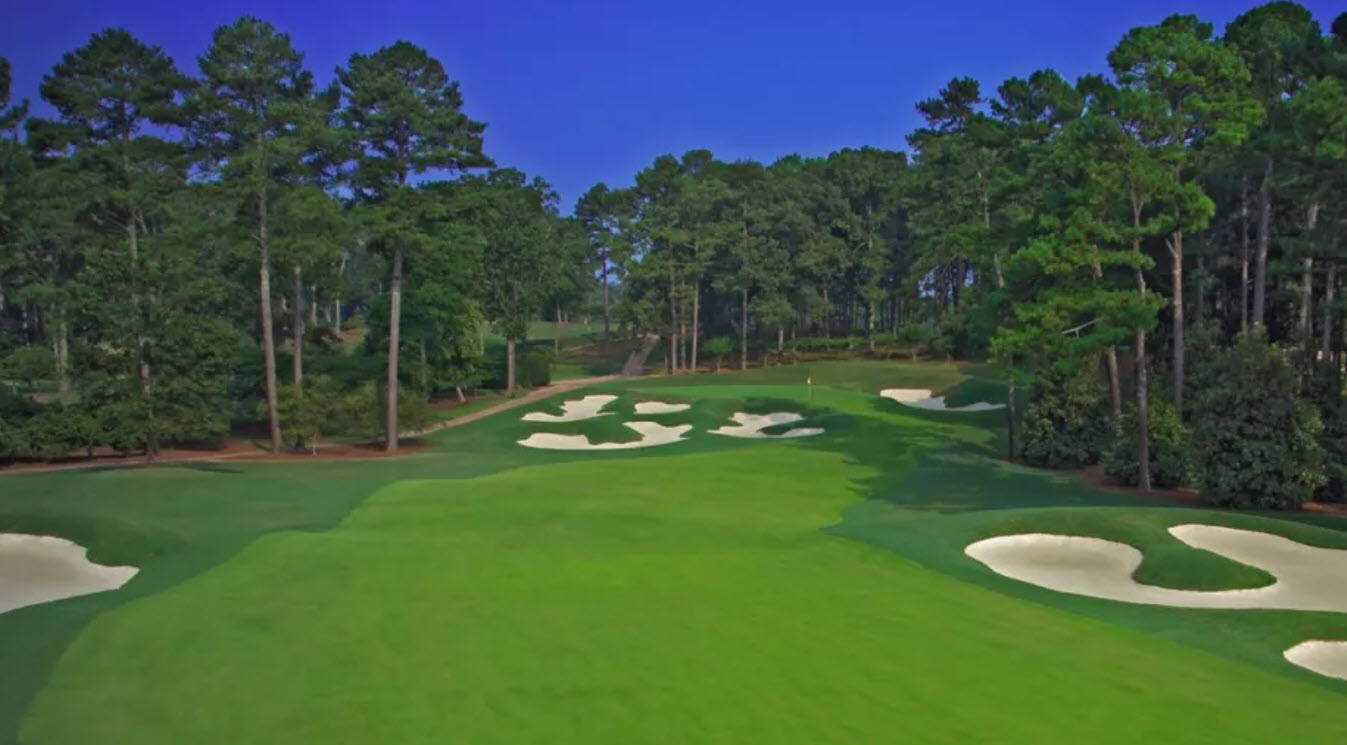 Scenic view of the Atlanta Athletic Club Highlands Course with lush green fairways and a water hazard.