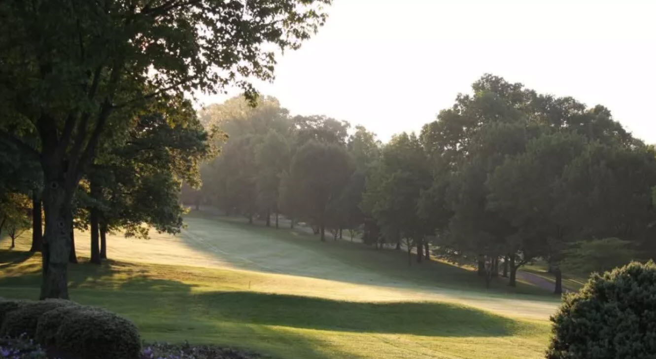 Scenic view of a hole at Country Club of York with lush green fairways and mature trees under a clear sky