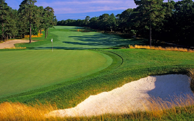 Panoramic view of a golf hole at Galloway National Golf Club with the bay in the background