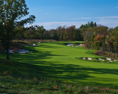 Panoramic view of the Highlands Course at Hamilton Farm Golf Club with lush fairways and mature trees under a clear sky.
