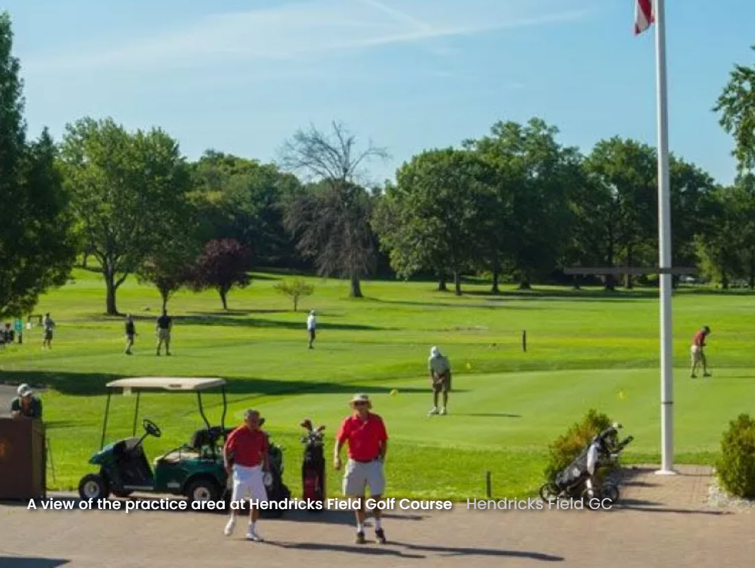 Overview of Hendricks Field Golf Course with green fairways and mature trees under a clear sky.