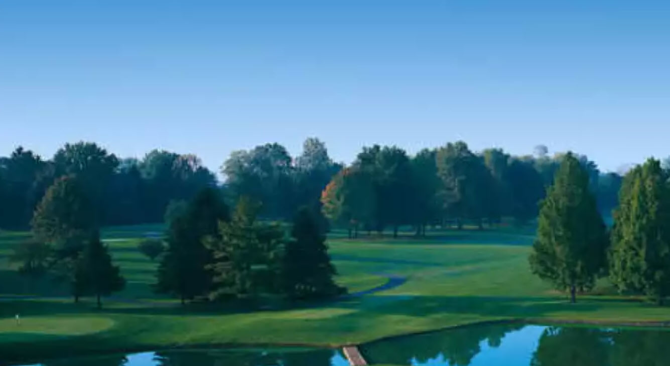View of a pristine green and fairway at Hershey Country Club East Course with trees in the background