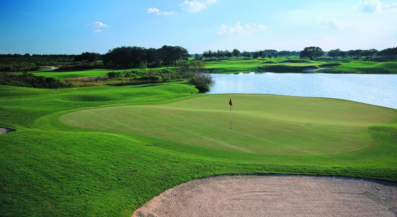 Scenic view of the Panther Lake golf course at Orange County National with rolling fairways and water hazards under a clear sky
