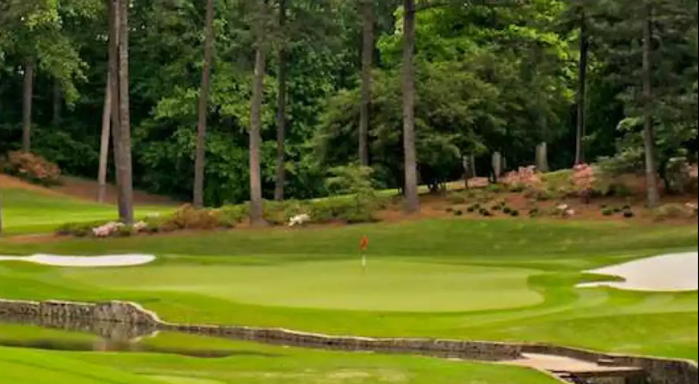 Aerial view of Peachtree Golf Club's pristine fairways and greens surrounded by mature trees in Atlanta, Georgia
