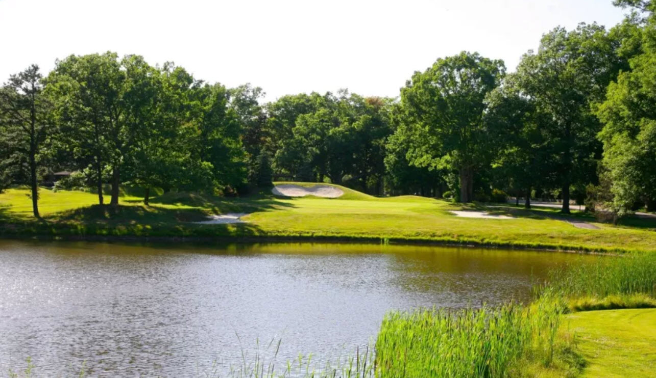 Scenic view of a green and fairway at Pocono Manor Golf Course with mountains in the background
