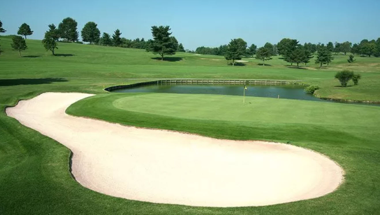 Panoramic view of the lush green fairways and tree-lined hills at Quicksilver Golf Club in Midway, Pennsylvania