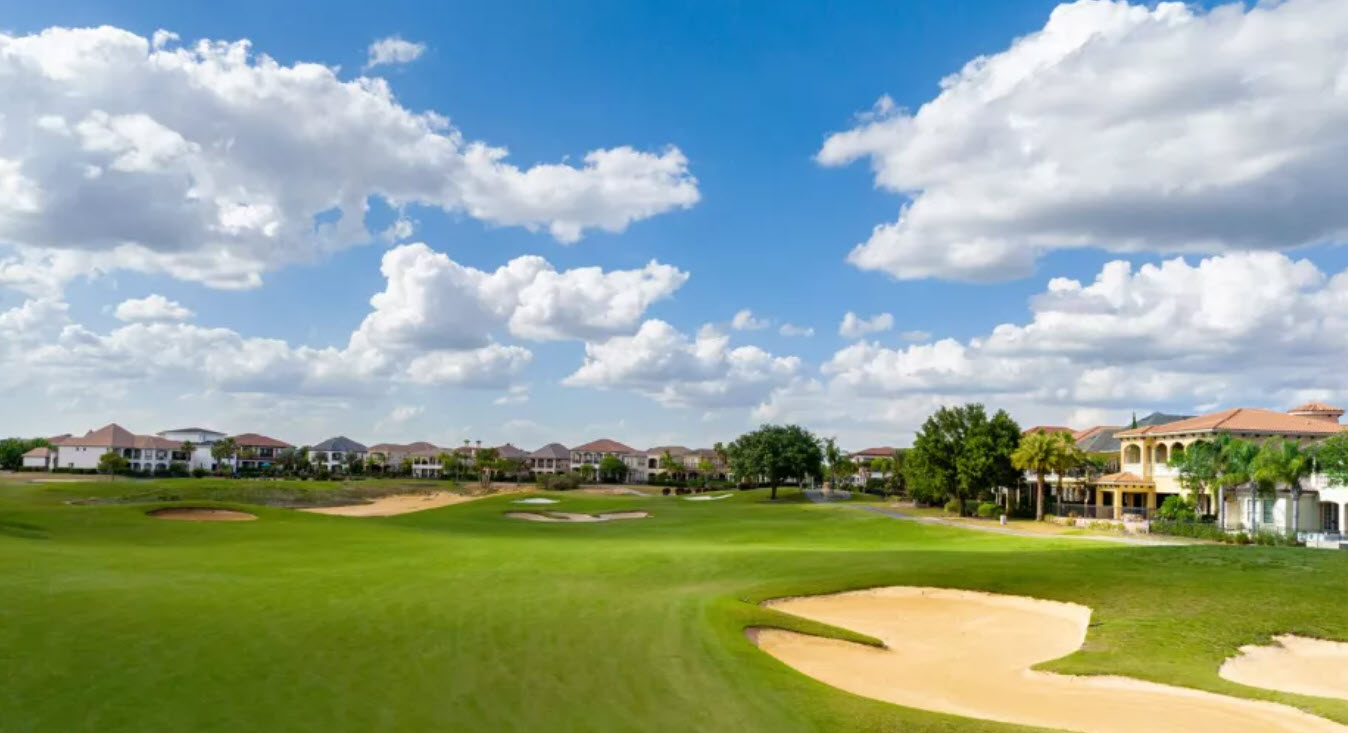 Scenic view of the 10th hole at Reunion Resort Nicklaus Course with water hazard and lush green fairways under a blue sky