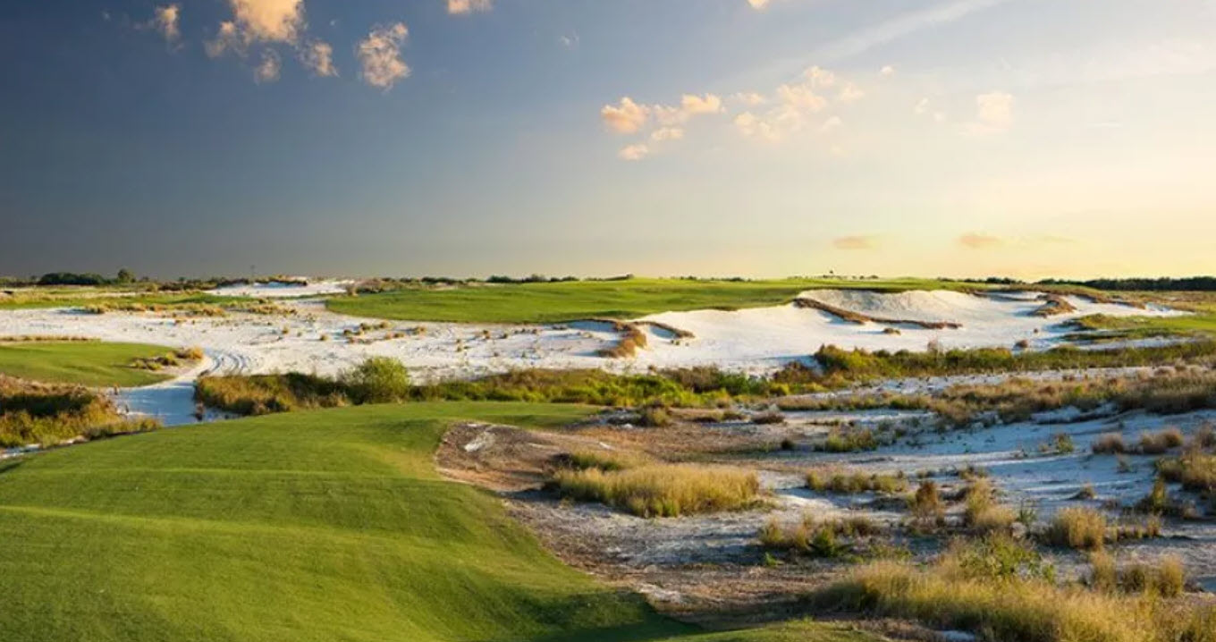 Expansive view of Streamsong Black golf course with wide fairways and large, undulating greens under a blue sky