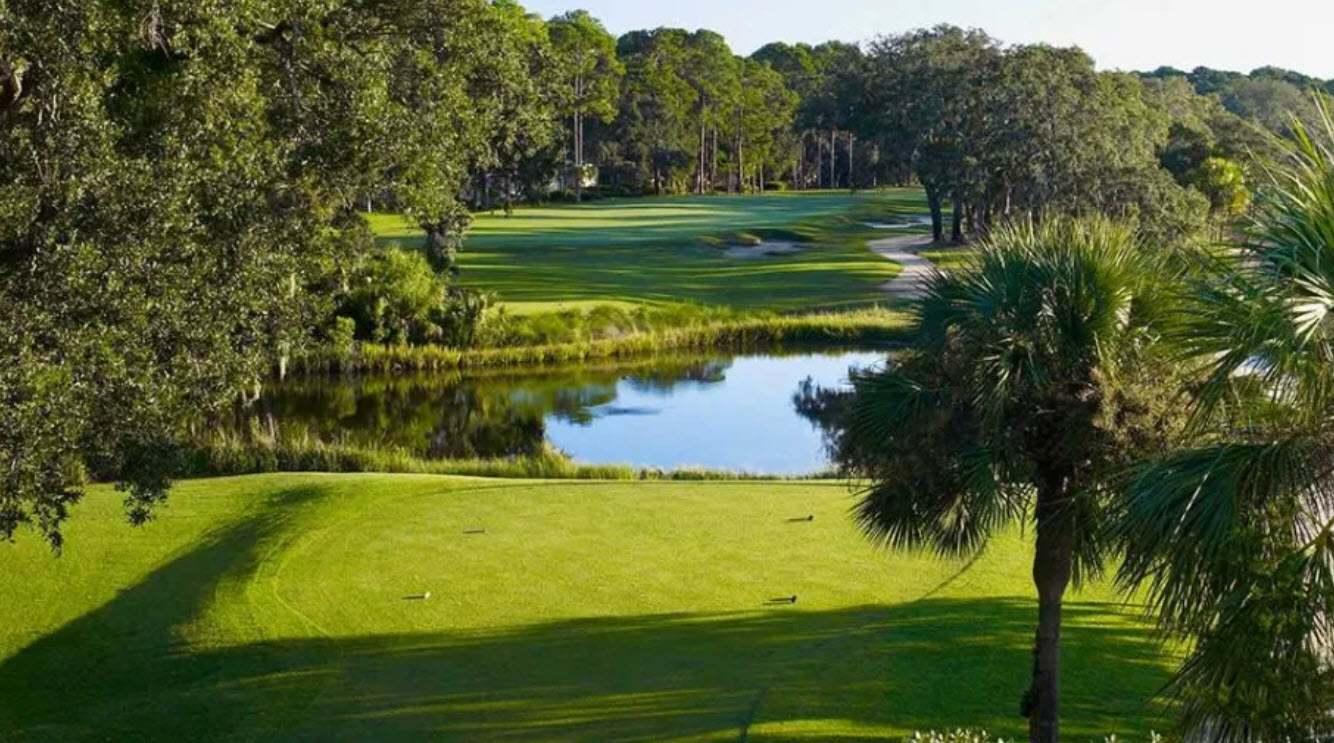 Aerial view of a golf hole at The Landings Club Marshwood Course with marshland in the background