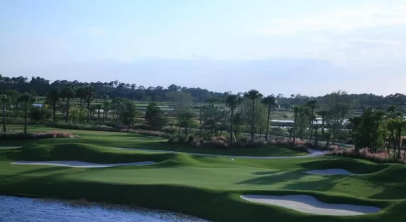 Overview of a green and fairway at TPC Treviso Bay with water hazards and lush Florida landscaping