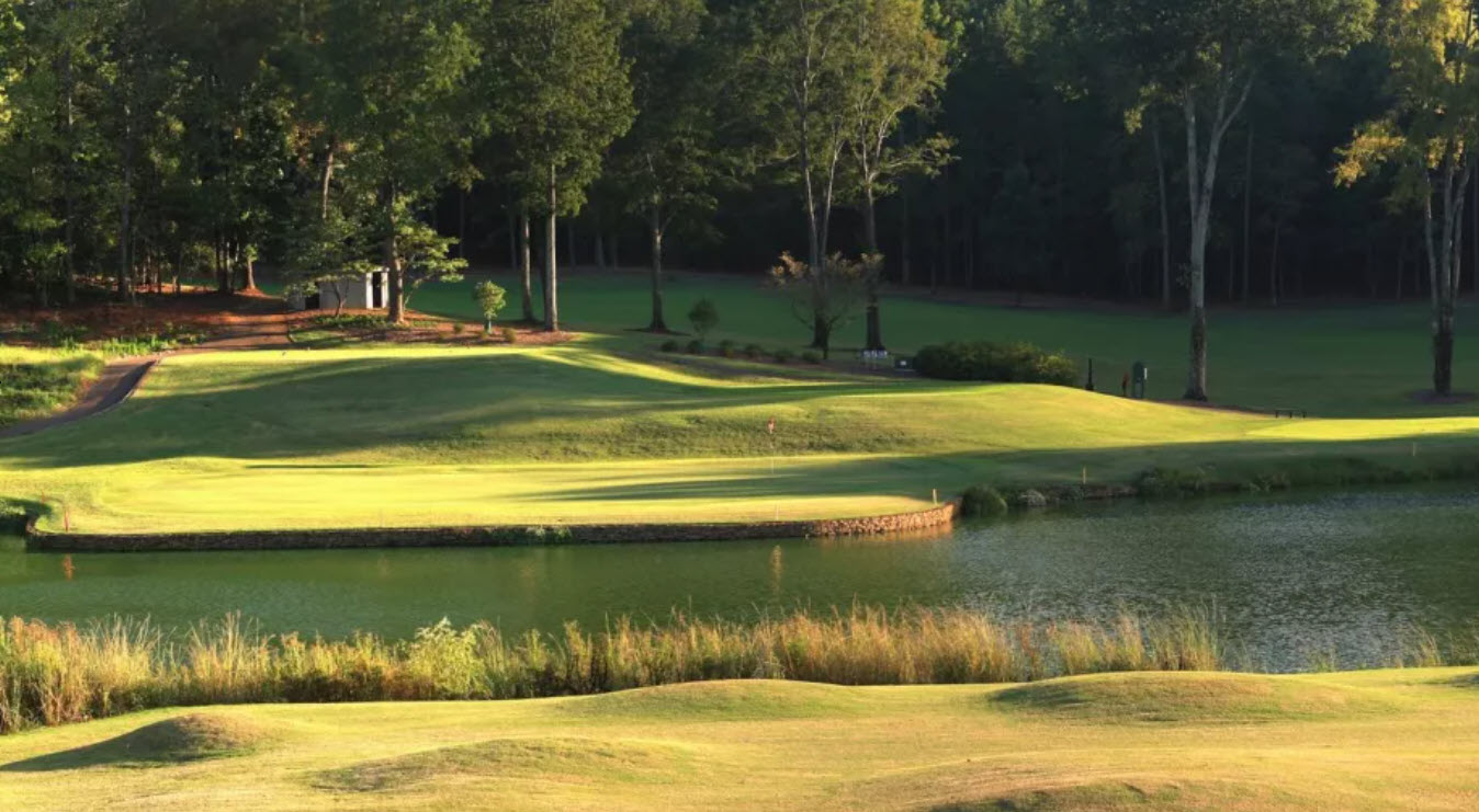 Panoramic view of the University of Georgia Golf Course with lush green fairways and mature trees under a clear sky