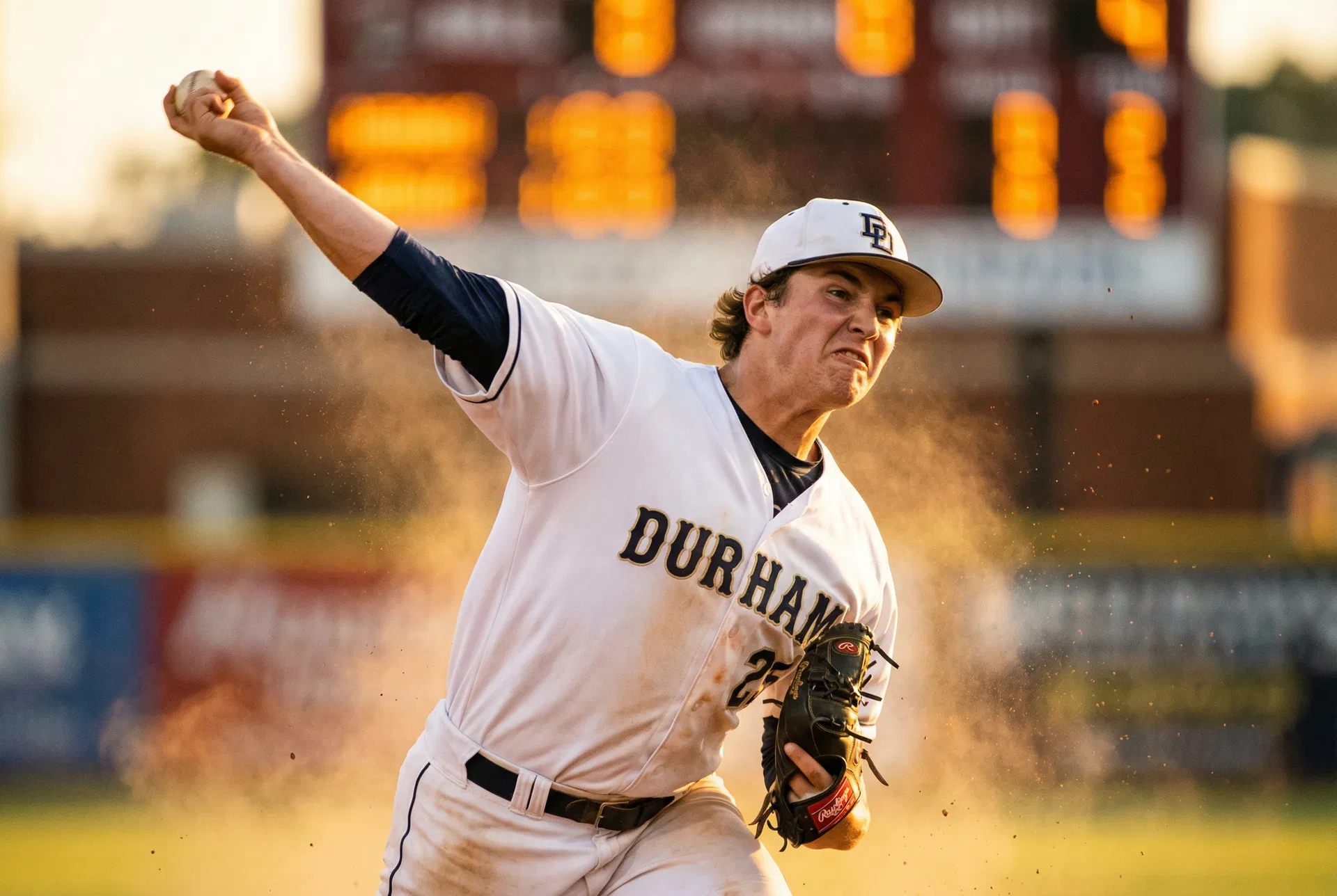 Young baseball pitcher throwing in golden hour light