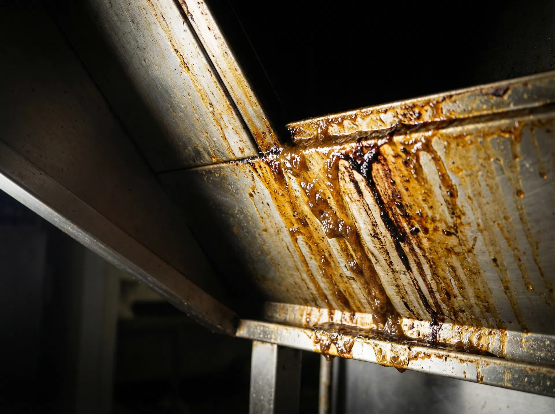 Thick grease deposits inside commercial kitchen extraction duct — a serious fire hazard