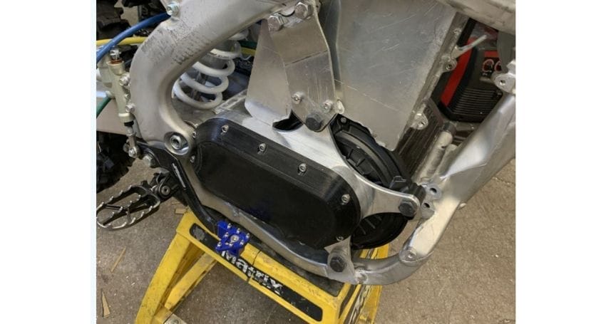 An electric bike conversion with a metal frame on a stand.