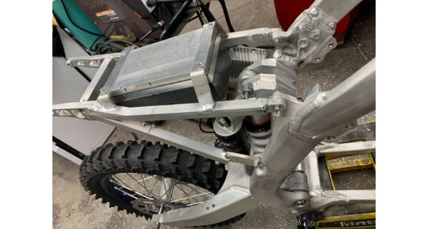 The frame of an electric bike is being put together.