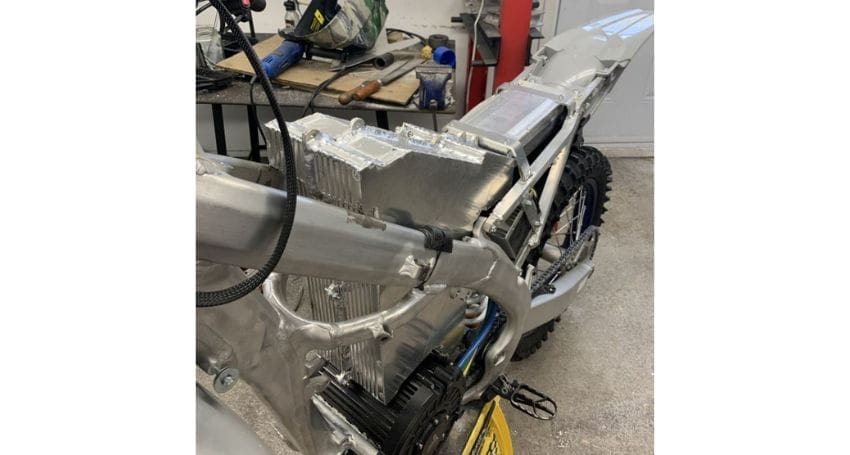An image of an electric dirt bike conversion in a garage.