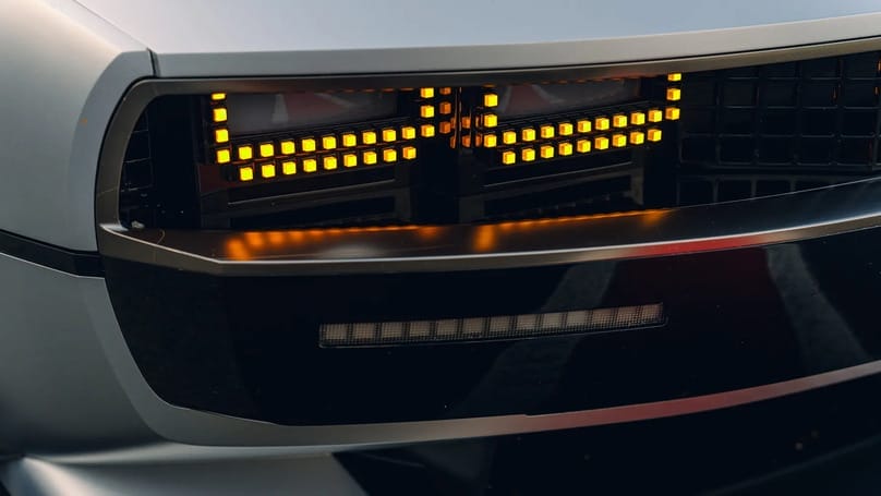 A close up of the headlights of a futuristic car.