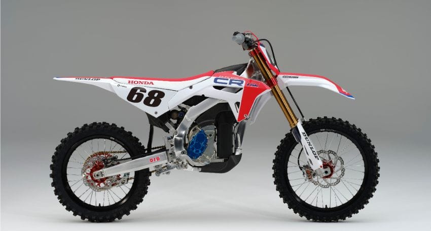 A red and white dirt bike on a white background, representing the Honda Racing Corporation.
