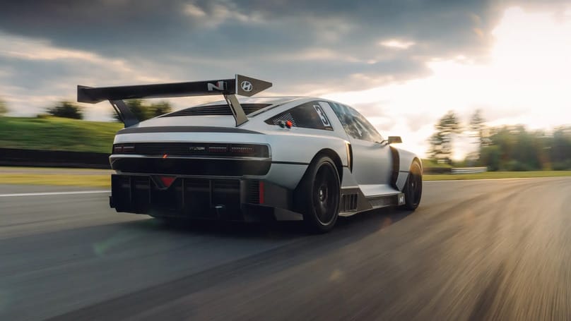 The porsche 911 gt3 rs is driving on a race track.