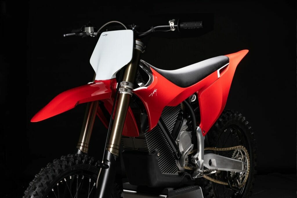 A red dirt bike is displayed on a black background - Stark Varg.