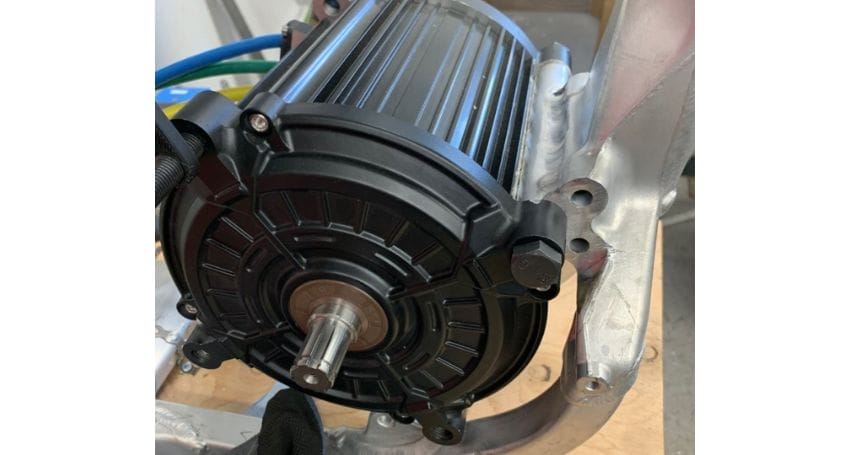 An electric motor attached to a piece of metal, commonly used for electric bike conversions.