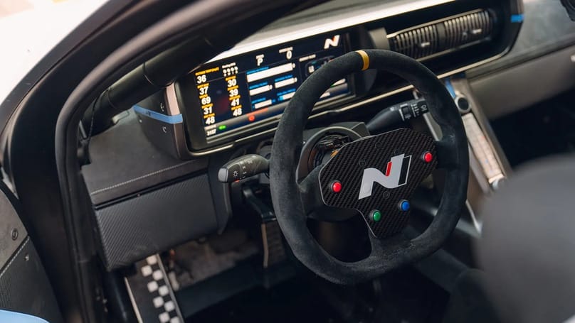 The interior of a racing car with a steering wheel and steering wheel.