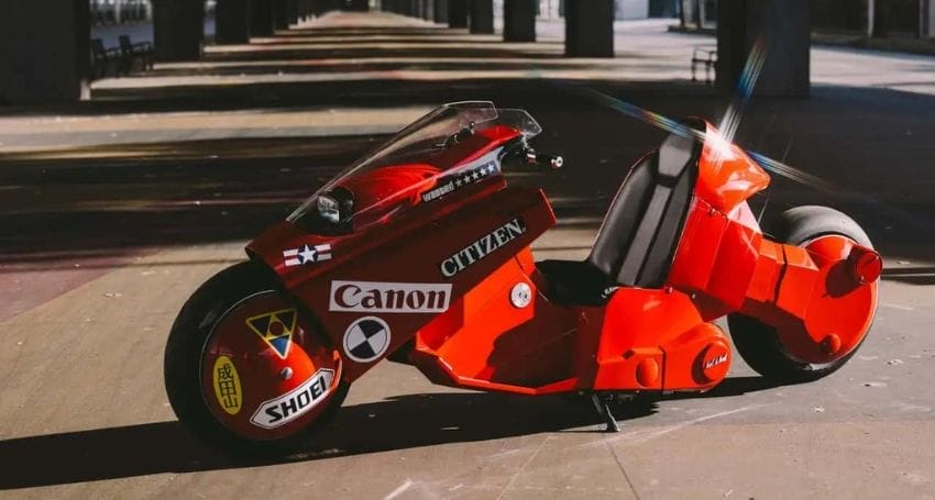 A red motorcycle parked in a parking lot.